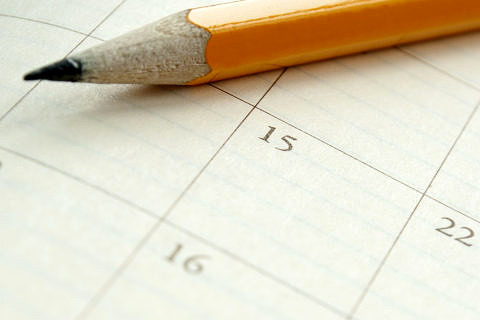 home calendar with dates and yellow sharpened pencil